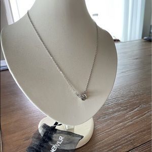 Silver necklace with banded diamond detail.